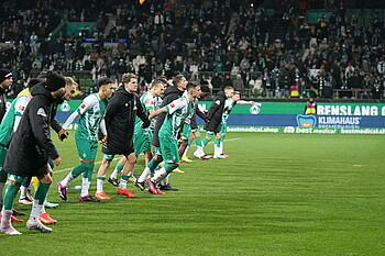 The team celebrating in a line after the end of the match
