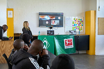 People are looking at a screen with a video call