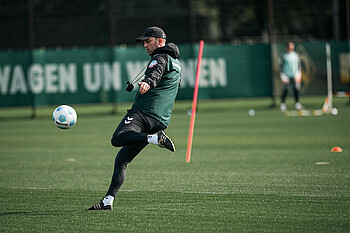 Ole Werner kicking a ball during training.