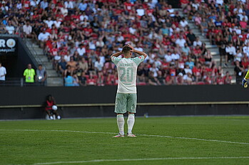 Romano Schmid clutching his head in his hands. 