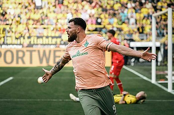 Oliver Burke celebrates after scoring the winning goal in Dortmund.