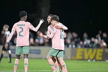Werder players celebrate their goal.