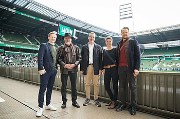 Dominik Kupilas steht mit Mitgliedern der ZfA-Gruppe im Weserstadion.