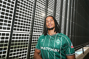 Isaac Schmidt wearing Werder's green home shirt at the Weserstadion.