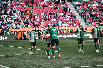 Weiser umarmt Deman und hält dabei den Ball in der Hand. 