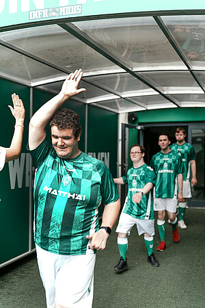 Die Werder Youngstars klatschen im Spieler*innentunnel des Weserstadions ab.