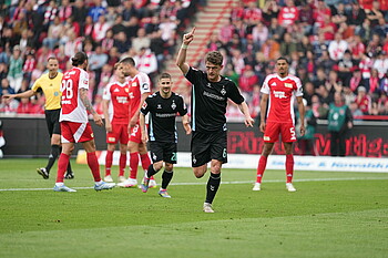 Jens Stage points to the sky in celebration.