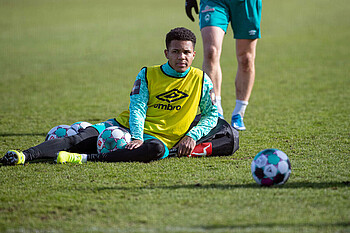 Felix Agu lying down during a Werder training session